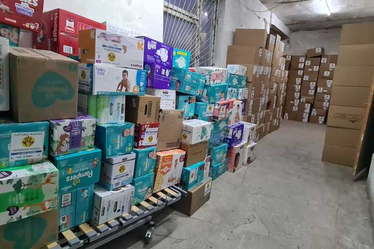 Stacked boxes of donated items in a hallway